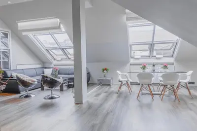 a living room with a table and chairs and windows at Luxury Apartment in Centre in Prague