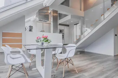 a dining room with a table and white chairs at Luxury Apartment in Centre in Prague