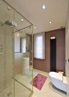 a bathroom with a glass shower and a toilet and a sink at Luxury Apartment in Centre in Prague