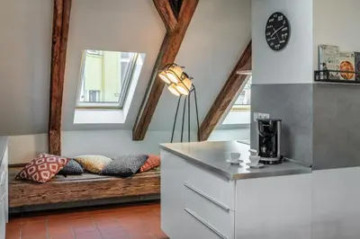 a kitchen with a couch with pillows on it at Three Bedroom Apartment with terrace Kepler-4 Art in Prague