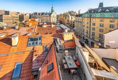 a view of roofs of buildings in a city at Three Bedroom Apartment with terrace Kepler-4 Art in Prague