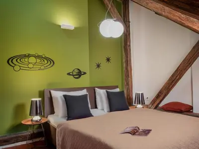 a bedroom with a bed and a green wall at Three Bedroom Apartment with terrace Kepler-4 Art in Prague