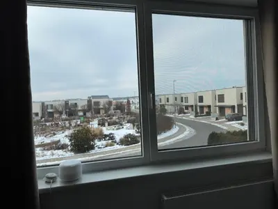 a window with a view of a snowy street at Villa with Terrace & private garden 30 min to Prague Center