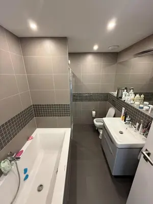 a bathroom with a tub and a sink and a toilet at Villa with Terrace & private garden 30 min to Prague Center