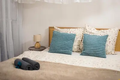 a bedroom with a bed with blue and white pillows at Art Apartment in Prague