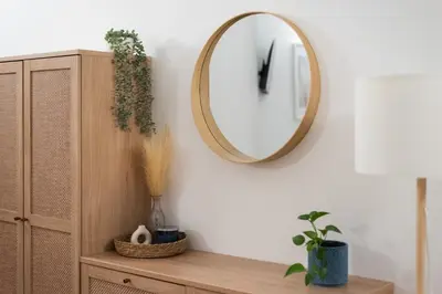 a mirror on a wall next to a wooden cabinet at Art Apartment in Prague