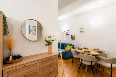 a dining room with a table and a mirror at Art Apartment in Prague