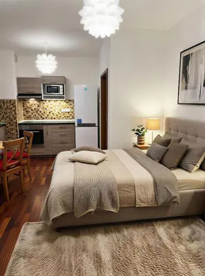 a bedroom with a large bed and a kitchen at Fortuna Garden II in Prague