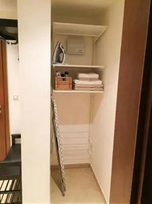 a room with a closet with a shelf and a ladder at Fortuna Garden II in Prague