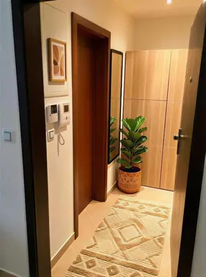 a hallway with a door and a potted plant at Fortuna Garden II in Prague