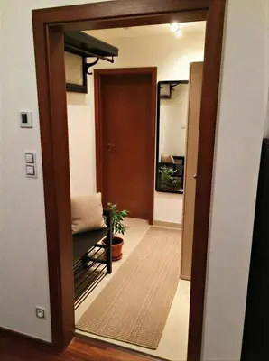 a door leading into a hallway with a mirror at Fortuna Garden II in Prague