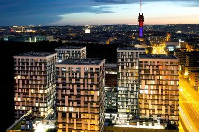 a view of a city at night with a television tower at Fortuna Garden II in Prague