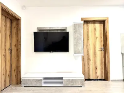 a living room with a flat screen tv on a wall at Comfortable apartmant in Prague in Prague