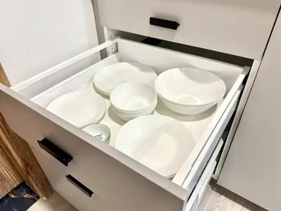 a drawer filled with white dishes in a cabinet at Comfortable apartmant in Prague in Prague