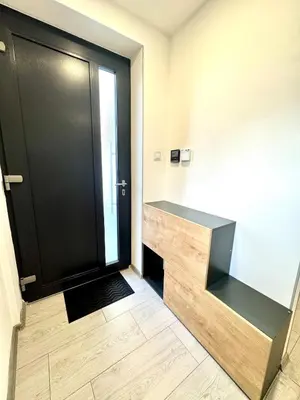 a large black door in a room with a wooden floor at Comfortable apartmant in Prague in Prague