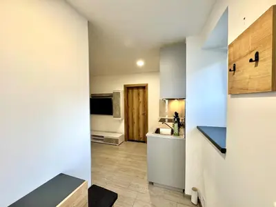 a kitchen with white cabinets and a counter top at Comfortable apartmant in Prague in Prague