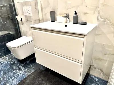 a white bathroom with a sink and a toilet at Comfortable apartmant in Prague in Prague