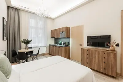 a bedroom with a large bed and a table at Premium City Center Apartment Prague - 4 Guests in Prague