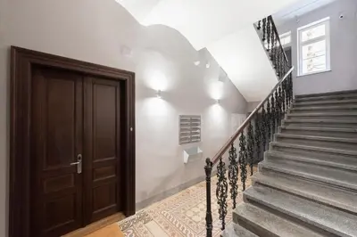 a staircase in a house with a wooden door at Premium City Center Apartment Prague - 4 Guests in Prague