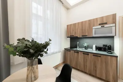 a kitchen with a table with a vase of flowers at Premium City Center Apartment Prague - 4 Guests in Prague