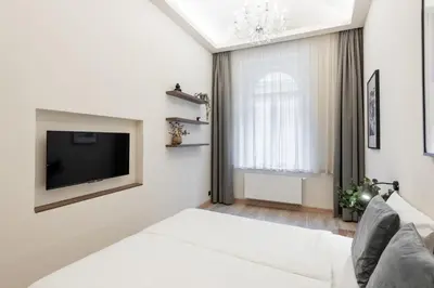 a living room with a tv and a couch at Premium City Center Apartment Prague - 4 Guests in Prague