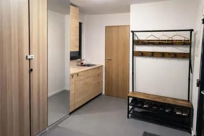 a small kitchen with a sink and a wooden cabinet at Studio Big Win Mělník in Pšovka