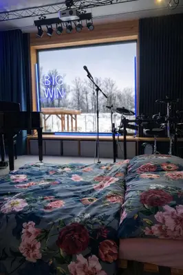 a bed in a room with a large window at Studio Big Win Mělník in Pšovka
