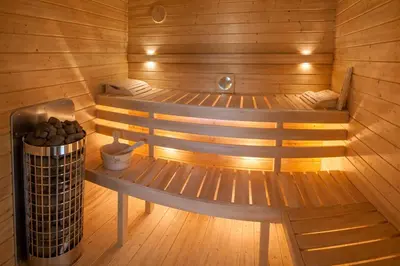 a wooden sauna with two benches and a trash can at Studio Big Win Mělník in Pšovka