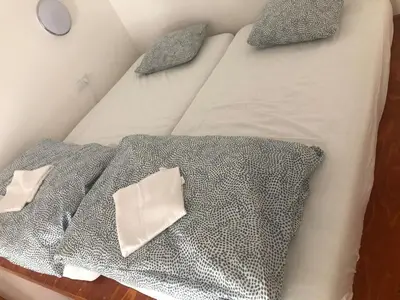 a bed with silver sheets and pillows on it at Central cozy rooms Soukenická S33 in Prague