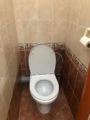 a bathroom with a white toilet in a room at Central cozy rooms Soukenická S33 in Prague