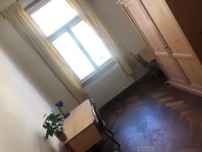 an attic room with a table and a window at Central cozy rooms Soukenická S33 in Prague