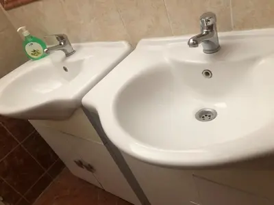a bathroom with a white sink and a white sink at Central cozy rooms Soukenická S33 in Prague