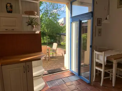a kitchen with a sliding glass door to a patio at Art nouveau villa with garden close to center in Prague