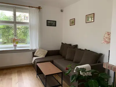 a living room with a couch and a table at Art nouveau villa with garden close to center in Prague