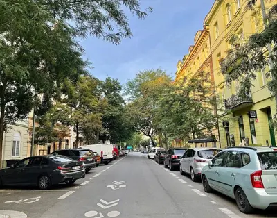 a street with cars parked on the side of the road at Charming 1BDR nest with balcony in Prague