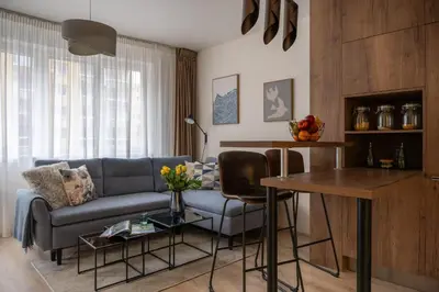 a living room with a couch and a table at Apartment near PVA Expo Prague & Concerts in Prague