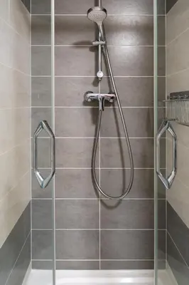 a shower with a shower head in a bathroom at Apartment near PVA Expo Prague & Concerts in Prague
