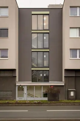 a building with windows and a street at Apartment near PVA Expo Prague & Concerts in Prague
