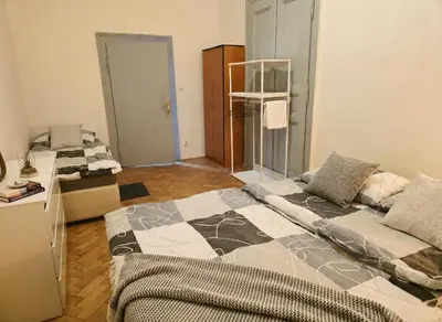 a room with two beds and a counter in it at Anhouse in Prague