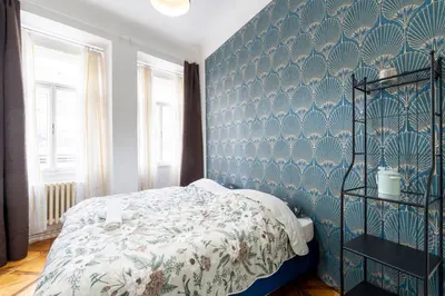 a bedroom with a bed and a blue wall at 2 bedroom apartment in New Town close to river in Prague