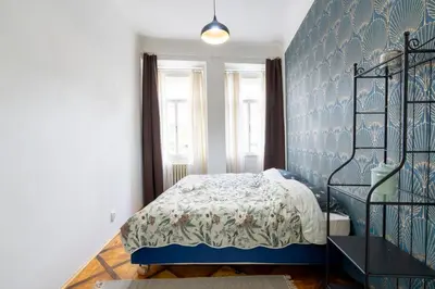 a bedroom with a bed and a blue wall at 2 bedroom apartment in New Town close to river in Prague