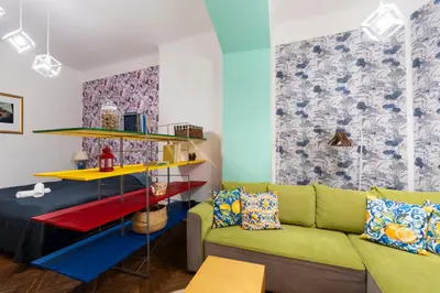 a living room with a green couch and a colorful wall at Apartment in Prague 1 next to Wenceslas Square in Prague