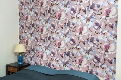 a bedroom with a pink and purple flower wallpaper at Apartment in Prague 1 next to Wenceslas Square in Prague