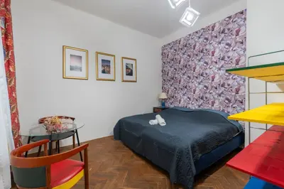 a small bedroom with a bed and a table at Apartment in Prague 1 next to Wenceslas Square in Prague