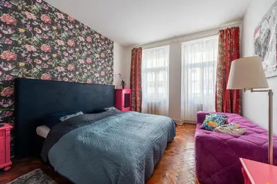 a bedroom with a purple bed and a purple chair at Cozy Central apartment by Charles Square in Prague