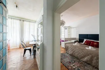 a bedroom with a bed and a table and a chair at Prime Location Modern flat in Prague centre in Prague