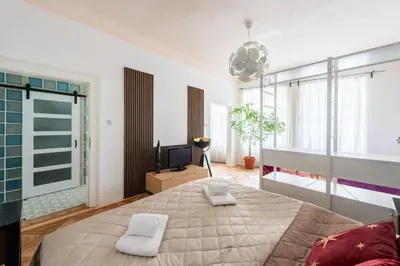a bedroom with a large bed and a television at Prime Location Modern flat in Prague centre in Prague