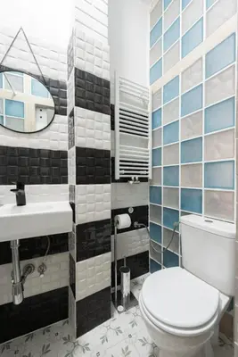 a bathroom with a toilet and a sink and a mirror at Prime Location Modern flat in Prague centre in Prague