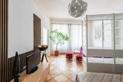 a living room with a bed and a television at Prime Location Modern flat in Prague centre in Prague
