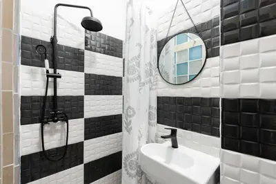 a black and white bathroom with a sink and a mirror at Prime Location Modern flat in Prague centre in Prague